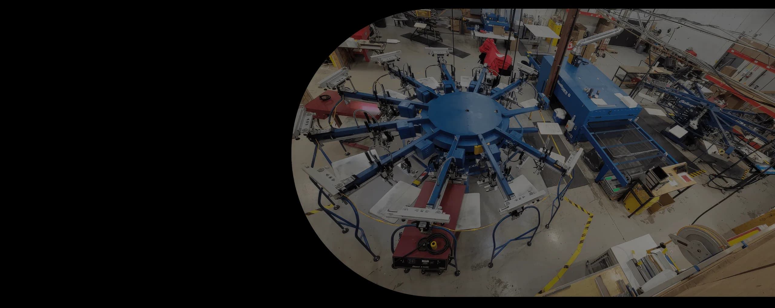 The Black Sheep Designs production floor — automatic screen printing carousel in action